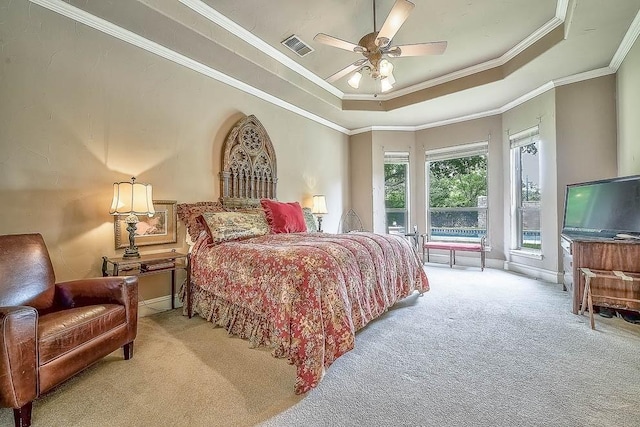 bedroom with access to exterior, a tray ceiling, visible vents, and light colored carpet