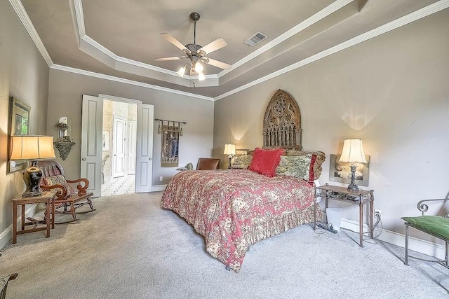 bedroom featuring a raised ceiling, visible vents, crown molding, and light carpet