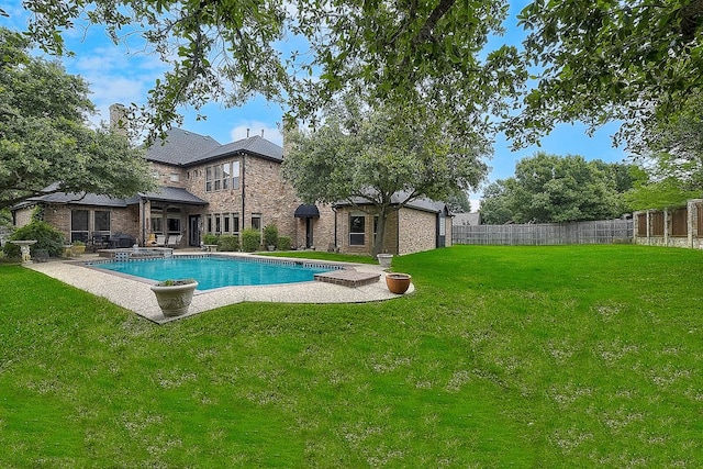 view of pool with a patio area and a yard