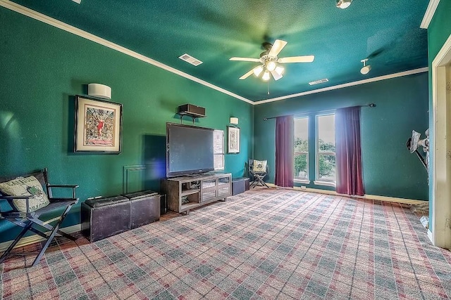 living room featuring baseboards, visible vents, and crown molding