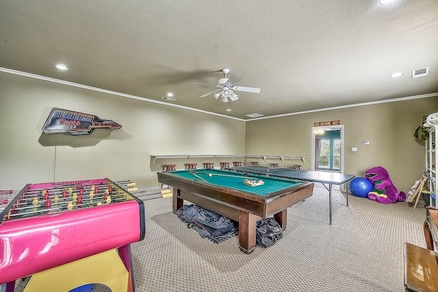 rec room with ornamental molding, visible vents, a textured ceiling, and carpet flooring