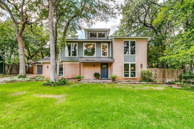 view of front of house featuring a garage and a front lawn