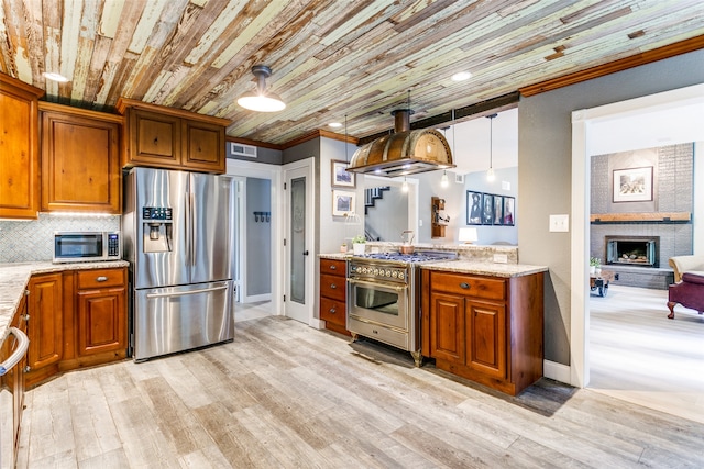 kitchen featuring stainless steel appliances, light hardwood / wood-style floors, wood ceiling, crown molding, and island exhaust hood