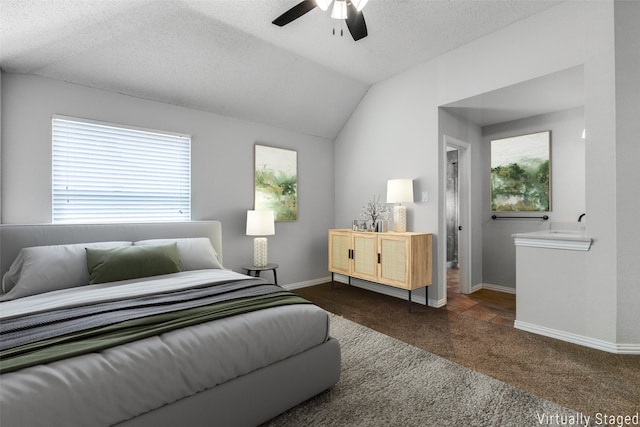 carpeted bedroom with vaulted ceiling, ceiling fan, and a textured ceiling