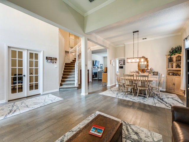 dining room with french doors, dark wood-type flooring, and crown molding