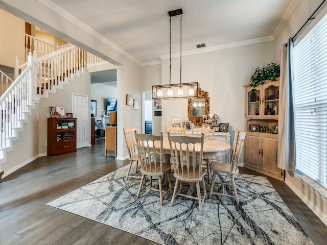 dining space featuring dark hardwood / wood-style floors and ornamental molding