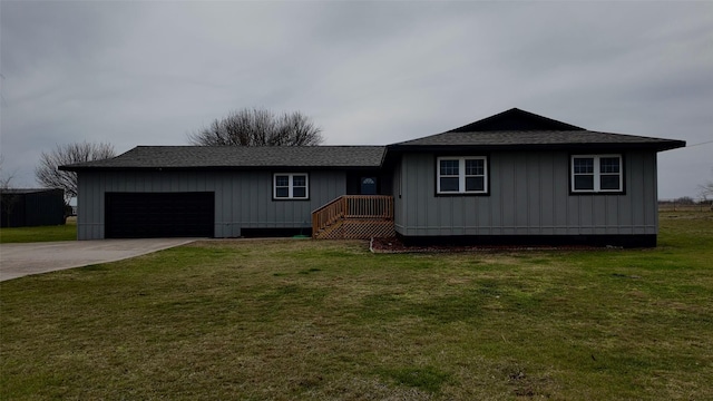 view of front of home with a garage and a front lawn