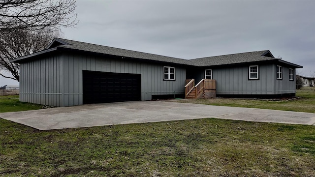 view of front of property with a garage and a front yard