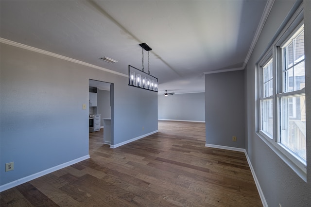 unfurnished dining area with ceiling fan with notable chandelier, ornamental molding, and dark hardwood / wood-style flooring