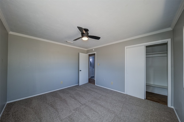 unfurnished bedroom featuring carpet floors, ceiling fan, crown molding, and a closet