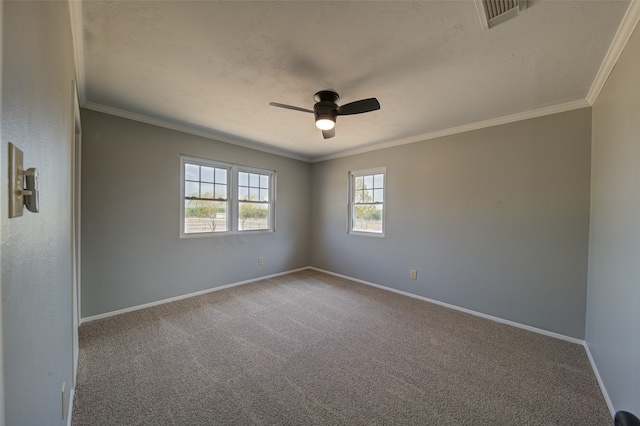 carpeted spare room featuring ceiling fan and ornamental molding