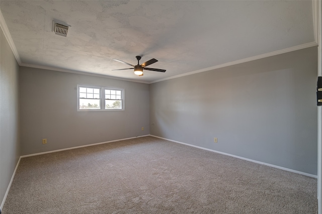 spare room with ceiling fan, carpet flooring, and crown molding