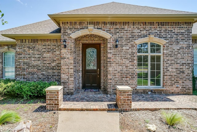 view of exterior entry featuring a patio