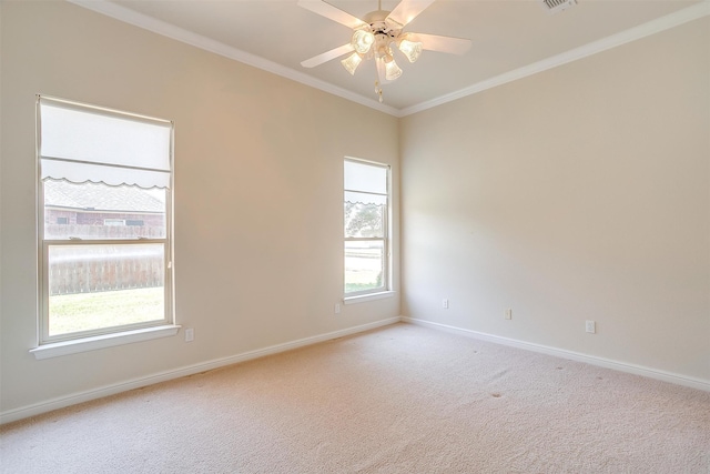 unfurnished room with ceiling fan, light colored carpet, and crown molding