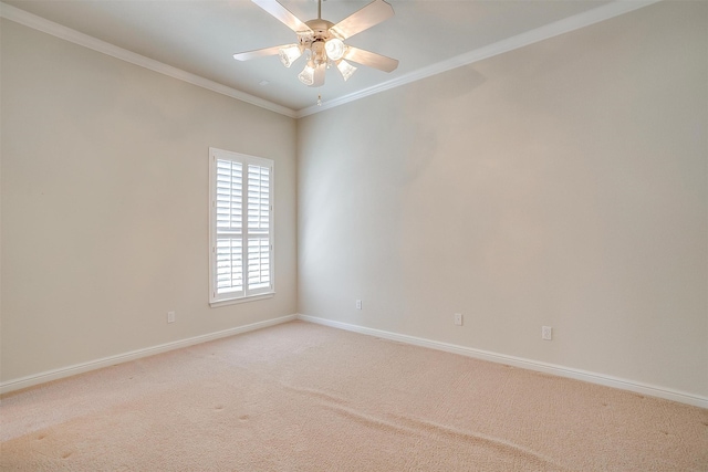 spare room with light carpet, ceiling fan, and crown molding