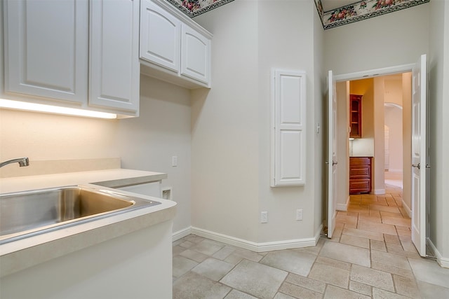 kitchen with white cabinetry and sink