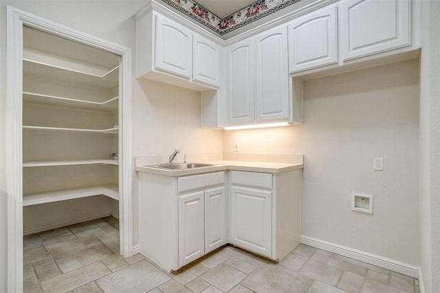 kitchen with sink and white cabinetry