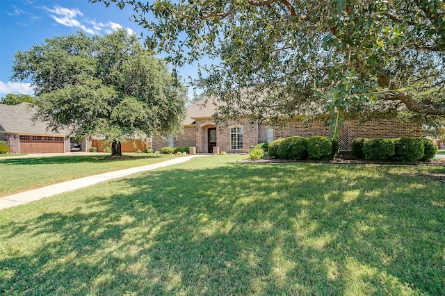 view of front of home with a garage and a front lawn