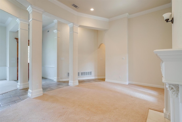 unfurnished living room with ornamental molding, light colored carpet, and ornate columns