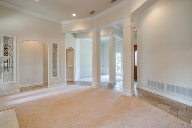 empty room with light carpet, ornamental molding, and decorative columns