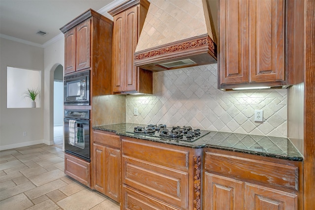 kitchen with backsplash, black appliances, custom exhaust hood, dark stone counters, and ornamental molding