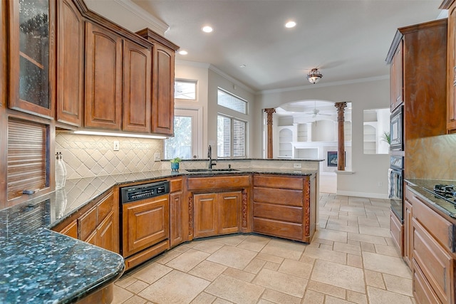 kitchen with ornamental molding, sink, backsplash, appliances with stainless steel finishes, and decorative columns