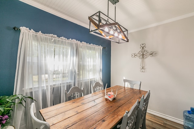 dining room with crown molding and dark hardwood / wood-style flooring