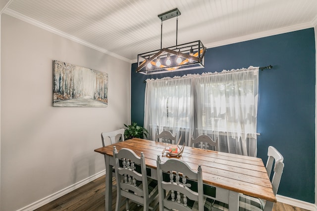 dining space featuring dark wood-type flooring and crown molding