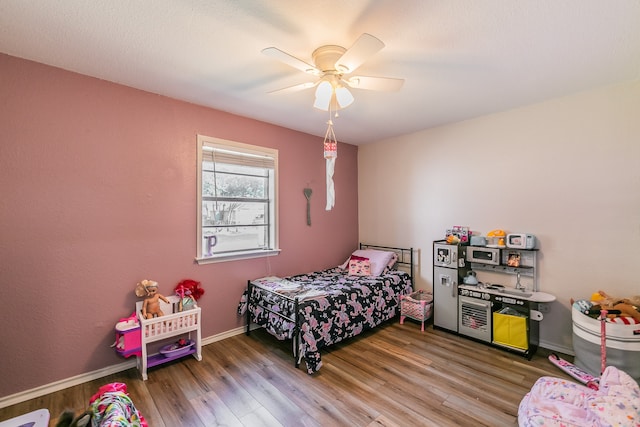 bedroom with hardwood / wood-style flooring and ceiling fan