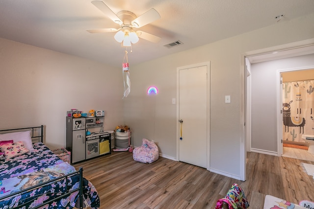 bedroom with ceiling fan and wood-type flooring