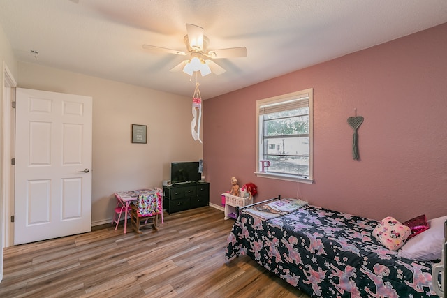 bedroom featuring ceiling fan and light hardwood / wood-style flooring