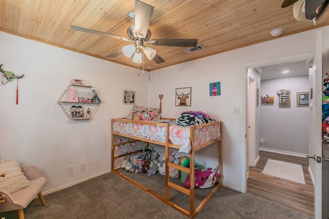 bedroom with ornamental molding, ceiling fan, wood ceiling, and dark hardwood / wood-style flooring