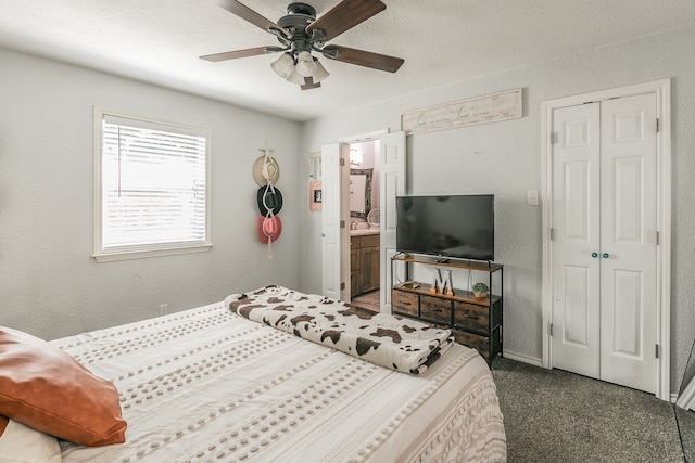 carpeted bedroom with ceiling fan, ensuite bath, a closet, and a textured ceiling