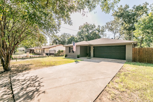 ranch-style home featuring a front yard and a garage