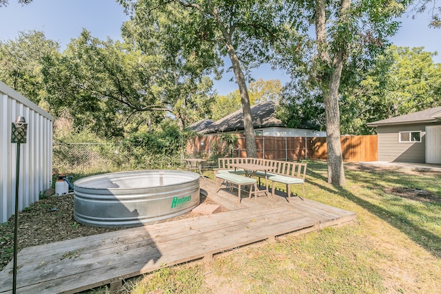 wooden deck featuring a yard