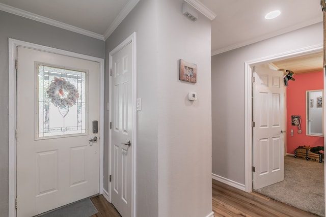 entryway featuring ornamental molding and hardwood / wood-style floors