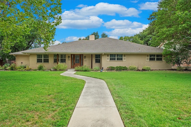 ranch-style home featuring a front lawn