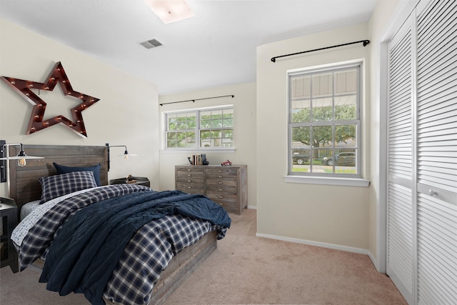 carpeted bedroom with a closet