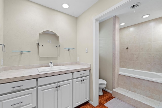 full bathroom with toilet, vanity, and tiled shower / bath combo