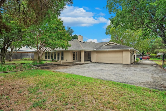 back of house with a yard and a garage