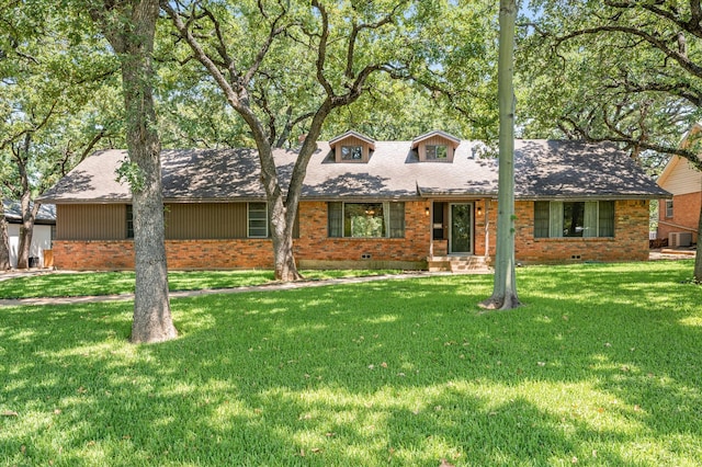 view of front of house featuring a front lawn and central AC unit