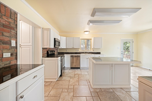 kitchen featuring sink, stainless steel appliances, white cabinets, and tile counters