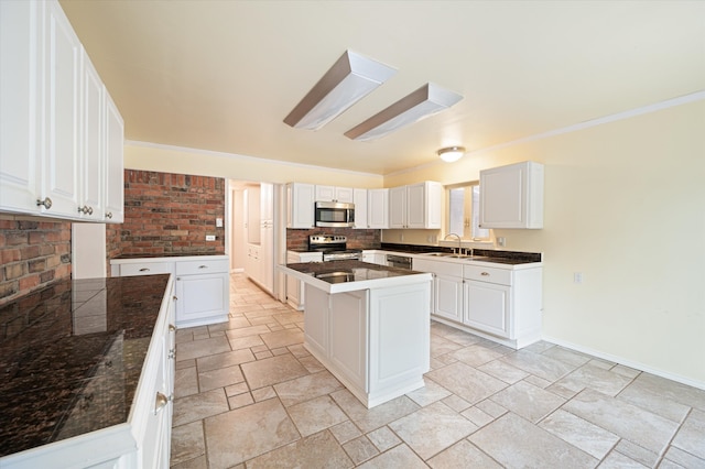 kitchen featuring backsplash, stainless steel appliances, white cabinetry, light tile patterned floors, and a center island