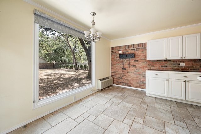 unfurnished dining area with light tile patterned floors, a wealth of natural light, an inviting chandelier, and ornamental molding