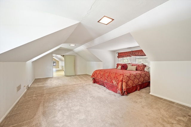 bedroom featuring vaulted ceiling and light colored carpet