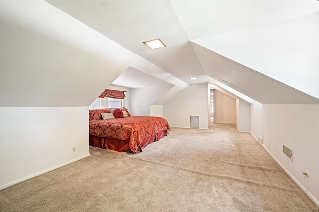 bedroom with vaulted ceiling and light colored carpet