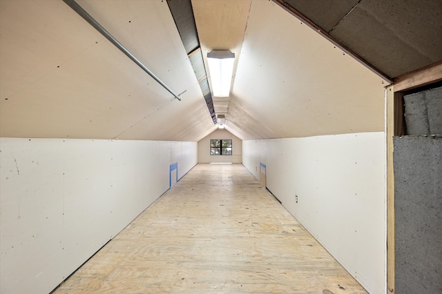 additional living space with light hardwood / wood-style floors and lofted ceiling