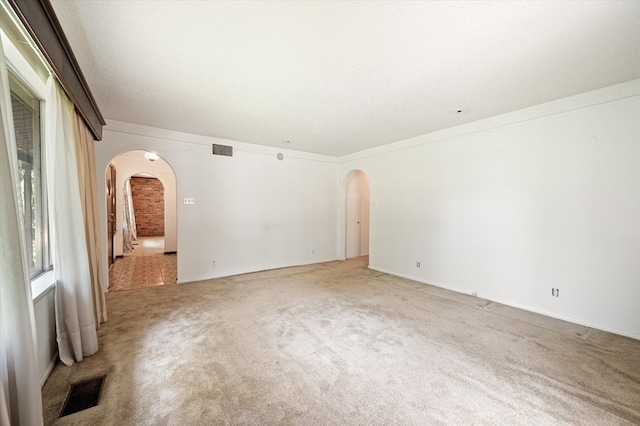 carpeted spare room with crown molding