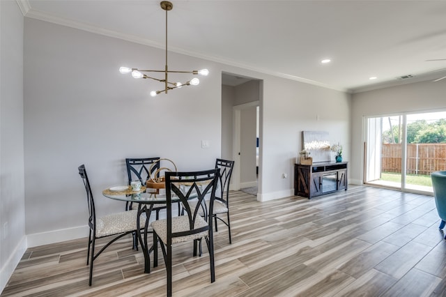 dining area featuring ceiling fan with notable chandelier, crown molding, and light wood-type flooring