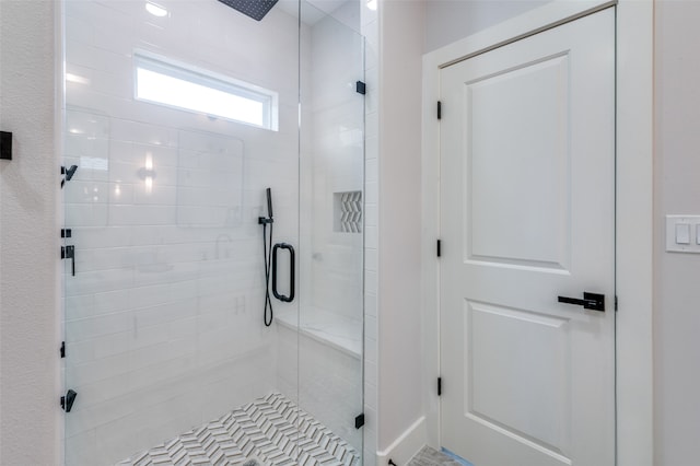 bathroom with a shower with shower door